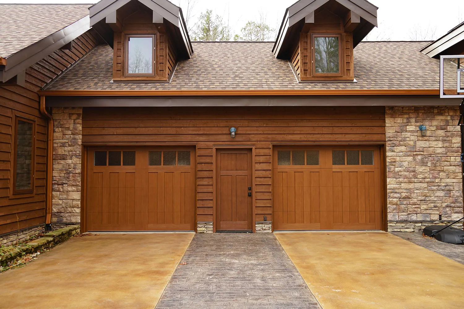 A Northgate Doors install: new carriage-house garage doors and matching entry door on a Chattanooga home
